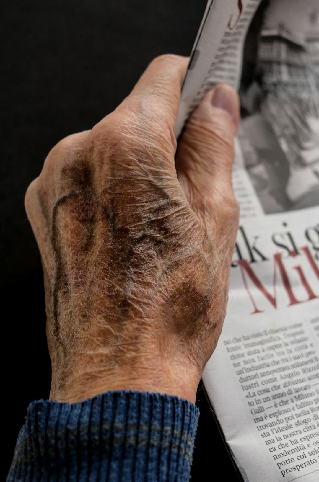 old hands holding photo